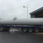 Section of steel chimney on the back of a flat bed truck
